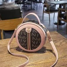 Leather elegant round waterproof ladies sling bag.